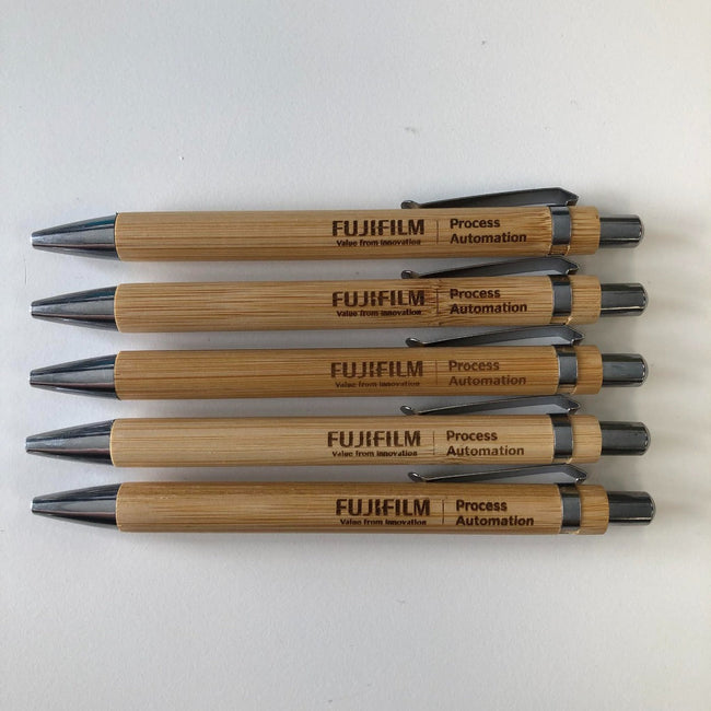 Custom corporate event gifts, these wood pens are personalised both sides with a company logo and attendee name