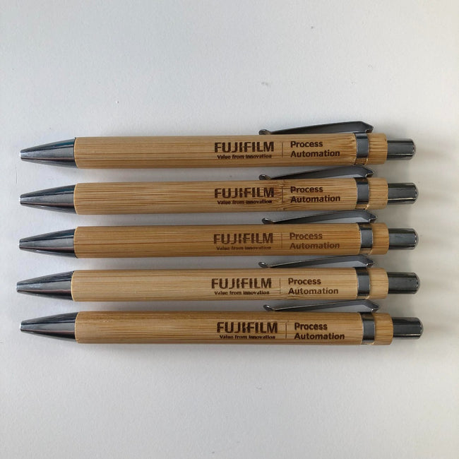 Custom corporate event gifts, these wood pens are personalised both sides with a company logo and attendee name